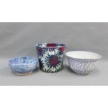 A contemporary floral patterned pottery planter and two sponge ware bowls, (3)