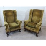 A pair of green velvet upholstered wing armchairs in the Carolean style with loose cushions and