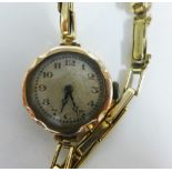 Lady's 9ct gold wrist watch on a 9ct gold bracelet strap