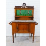 Art Nouveau mahogany washstand with green tiled back, marble top and two cupboards to the base,
