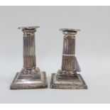 A pair of silver desk candlesticks, Chester 1895 , 13cm high (2) (a/f)