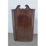 19th century mahogany corner cabinet with a swan neck pediment top and green painted interior with