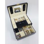 Black leather jewellery box containing a collection of costume jewellery to include earrings,