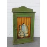 Green painted cupboard with still life jugs pattern to the front panel, 45 x 73 x 14cm