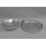 Alessi stainless steel tray of circular form with a studded rim and ebonised handles, together