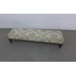 Long footstool with a floral upholstered top and short cabriole legs, 100 x 20 x 28cm