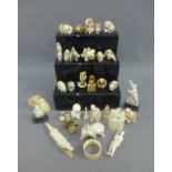 A large collection of early 20th century ivory okimonos, etc, together with later marine ivory