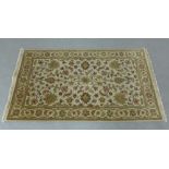 Eastern rug, the beige field with an allover foliate pattern and flowerhead border, 150 x 90cm