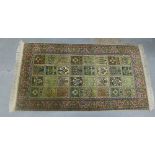 Pakistan rug, with olive field and four rows of fifteen rectangular panels, 160 x 89cm