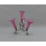 Art Nouveau style metal epergne with four cranberry glass trumpet shaped inserts, 31cm high