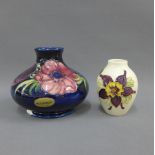 Moorcroft Anemone pattern vase, 10cm high, and another smaller (chip to the footrim) (2)