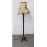Mahogany standard lamp with brass feet and a ruched style shade, 142cm to top of fitting
