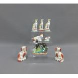 Pair of Staffordshire spaniels, porcelain hounds and a cow and calf, tallest 11cm (8)
