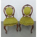 Pair of 19th century rosewood framed side chairs with carved oval backs with upholstered back panels