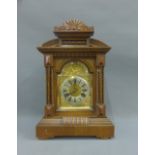 Oak cased mantle clock with a silvered chapter ring and Roman numerals with brass spandrels, 45cm