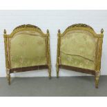 A gilt gesso French style daybed, the ends with a carved fruit and leaf top rail and upholstered
