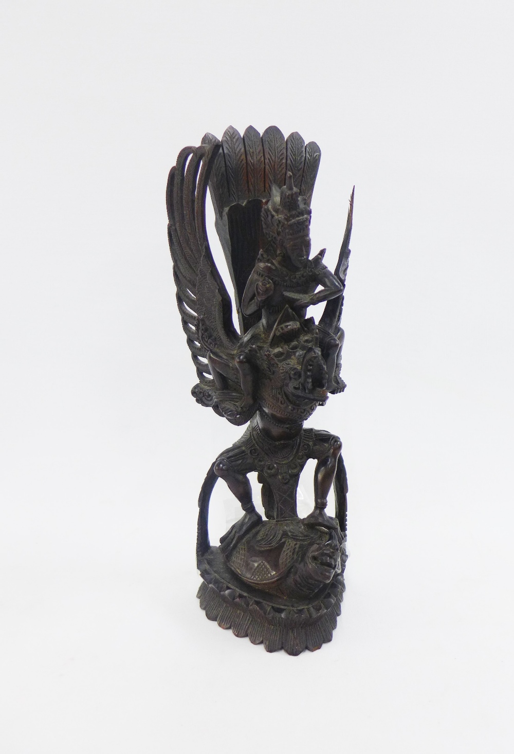 Vishnu astride Garuda, a hardwood carving (a/f) 33cm high