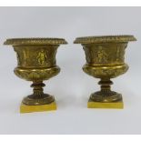 Pair of ormolu campana vases with beaded rims and frieze of classical figures, on socle bases, 13.