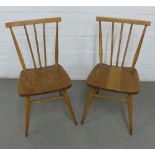 A pair of vintage Ercol beech and elm stick back chairs with solid seats and turned tapering legs,