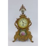 French gilt metal mantle clock with porcelain finial and plaques, movement is numbered 676, 37cm