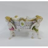 A Continental porcelain basket, raised on cherub supports, 23 x 13cm