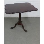 Mahogany tilt top table, the table with a scalloped edge, raised on a fluted column with carved