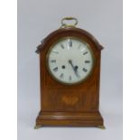 Early 20th century oak cased mantle clock, with inlaid butterfly pattern, on four brass feet with