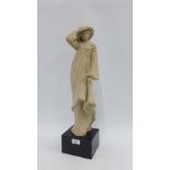 Austin productions figure of a lady wearing a hat and long coat, on a black plinth base, signed