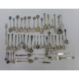 A quantity of silver and white metal souvenir teaspoons, pickle forks, etc (a lot)
