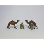 Two miniature cold painted spelter Camels and a small white metal Temple pendant charm, tallest 2.
