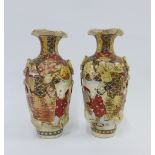 Pair of Japanese earthenware vases, painted with figures and with moulded loop handles. 26cm high