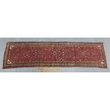 Eastern wool runner, red field with ivory spandrels and border, 285 x 77cm