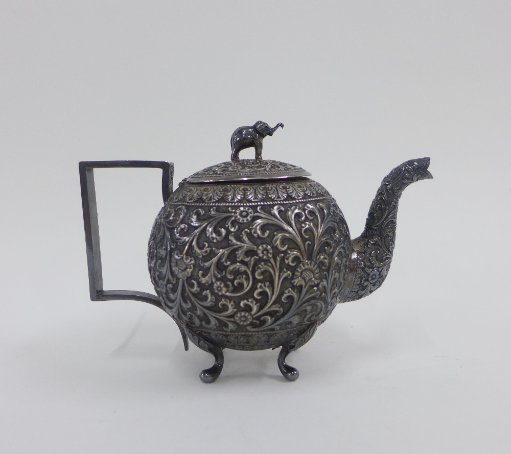 Eastern white metal teapot, the lid with an elephant finial, 12cm high