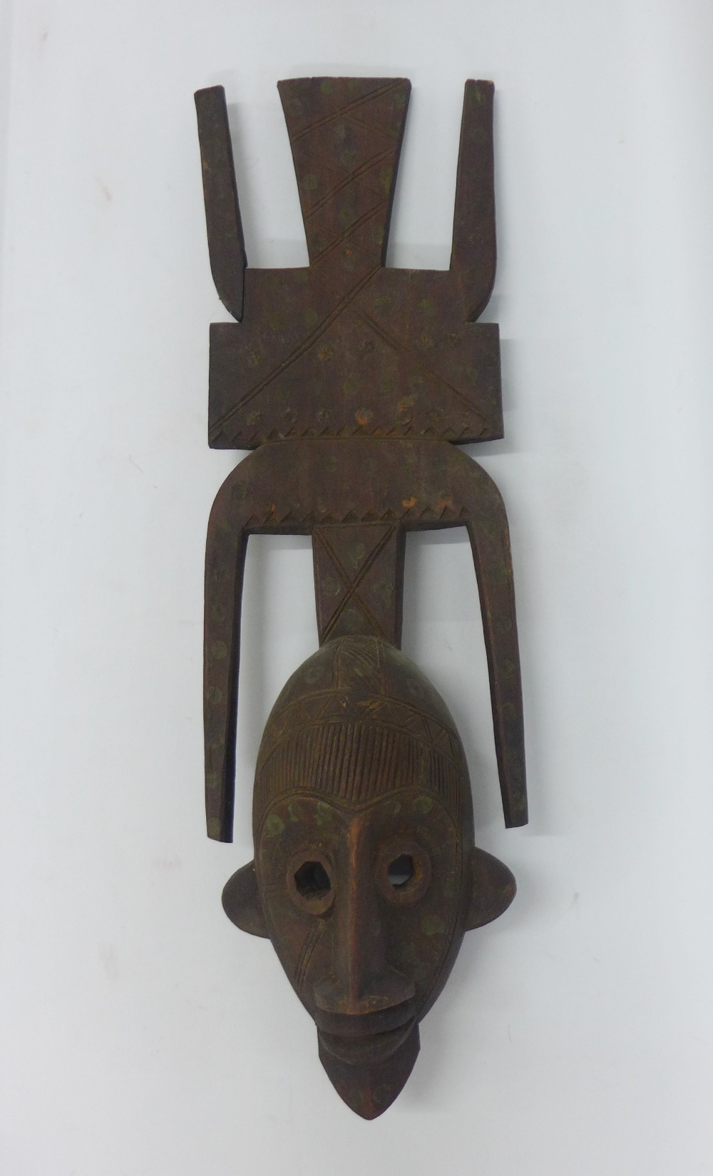 Mali wooden face mask with a large oval face, having decorative eyes and large flat decorated