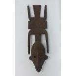 Mali wooden face mask with a large oval face, having decorative eyes and large flat decorated