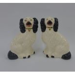 Pair of black and white glazed pottery chimney spaniels, 18cm high 92)