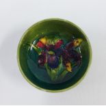 Moorcroft green glazed pin dish with Irises pattern, paper label and impressed facsimile