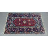 Eastern rug, red and blue field, central pole medallion and geometric borders, 186 x 120cm