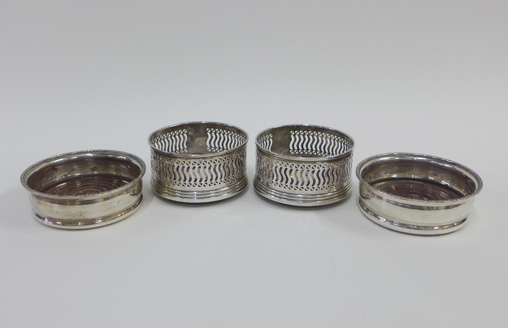 A pair of Scottish silver wine slide coasters, Edinburgh 1991, and another pair with hallmarks for