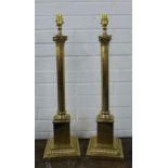 A pair of faux brass corinthian column table lamps with large cream coloured shades, (2)