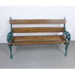 Garden bench with cast iron ivy leaf pattern ends, painted green, with wooden slats 152 x 89 x 60cm