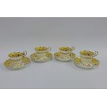 Set of four English porcelain cups and saucers with floral pattern and yellow ground, (4)