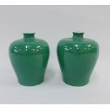 A pair of Chinese apple green glazed meiping vases with a craquelure ground, each with six character