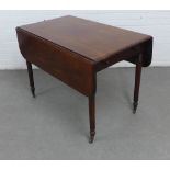 Victorian mahogany Pembroke table with bun handles and ring turned legs terminating on brass caps