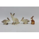 Three Winstanley pottery figures of Hares of various size and shape, signed, together with a John