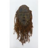 Ivory Coast wooden Fire mask with plaided fabric hair and beard, approx 35cm