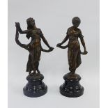 Pair of bronze female figures on circular ebonised bases, 29cm (2)