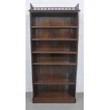 Mahogany open bookcase with a three quarter spindle gallery to top, 85 x 180 x 32cm