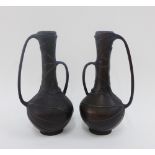 A pair of Japanese bronze vase with lotus leaf pattern and lop handles, on plain circular foot rims,