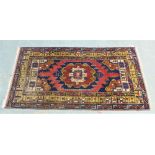 Eastern wool rug, the blue field with central geometric motif , the borders with buildings and